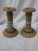 A pair of good Doulton Lambeth candlesticks.