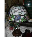 A table lamp with Tiffany style shade.