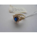 A 9ct gold white and blue stone ring with textured shoulders, Birmingham 1978, size M.