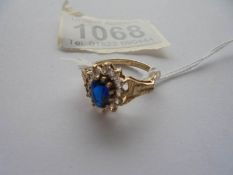A 9ct gold white and blue stone ring with textured shoulders, Birmingham 1978, size M.