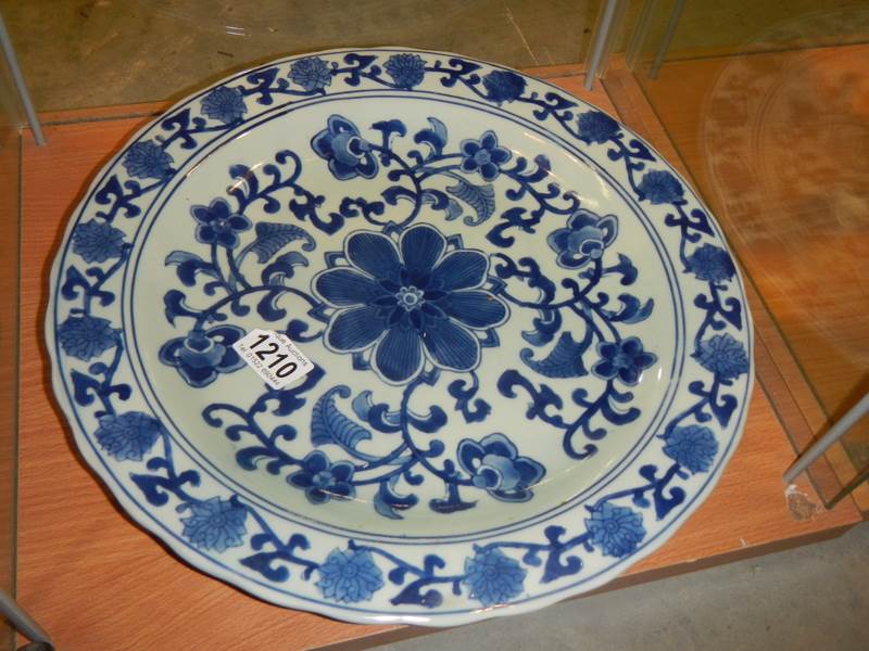 A large oriental blue and white plate.