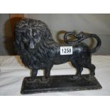 A Victorian cast iron lion door stop.