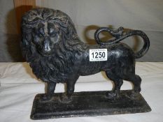 A Victorian cast iron lion door stop.