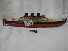 An early 20th century tin plate clockwork ocean liner by Arnold, Germany, 32 cm long.