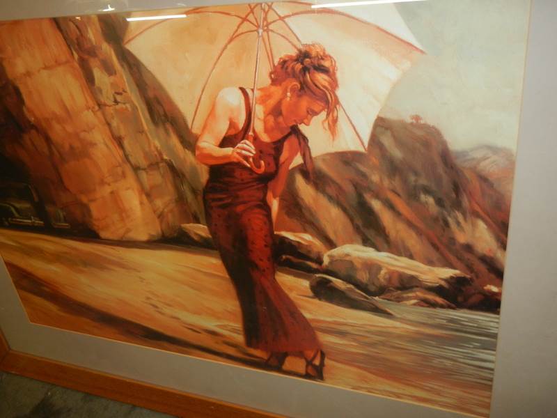 A framed and glazed beach scene featuring a lady with a parasol. - Image 2 of 3