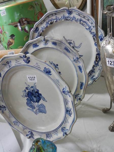 Three Delft style blue and white plates.