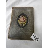 An antique postcard album containing many historical photographs and postcards.