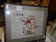 A framed and glazed Chinese embroidery featuring birds.