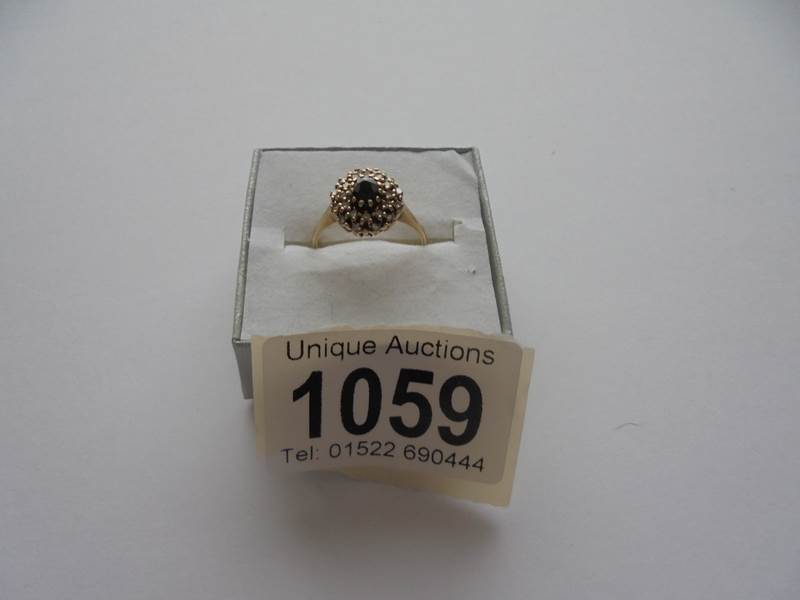 A sapphire and diamond ring in 9ct gold, dated London 1983, size N.