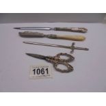 A silver letter opener (25 grams), a silver handled letter opener, silver handled scissors
