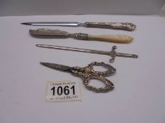 A silver letter opener (25 grams), a silver handled letter opener, silver handled scissors