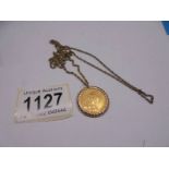 An 1889 Victoria gold sovereign on a yellow metal chain.