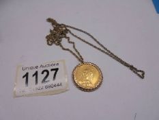 An 1889 Victoria gold sovereign on a yellow metal chain.