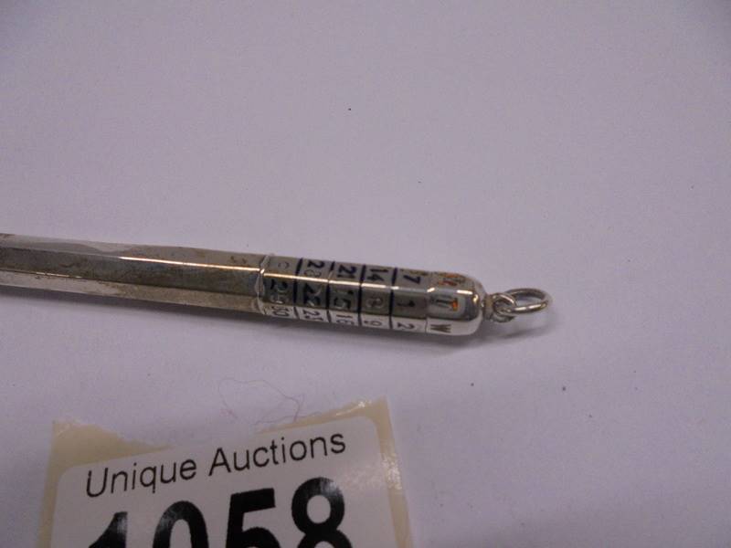 A calendar propelling pencil in unmarked white metal. - Image 2 of 2