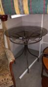 A smoked glass top wrought iron garden table, COLLECT ONLY