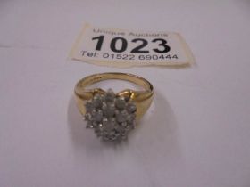 A gold cluster ring, size J half, 3.7 grams.