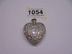 An embossed silver heart shaped perfume bottle as a pendant, 13 grams.
