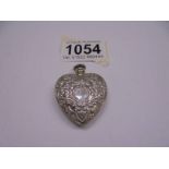 An embossed silver heart shaped perfume bottle as a pendant, 13 grams.