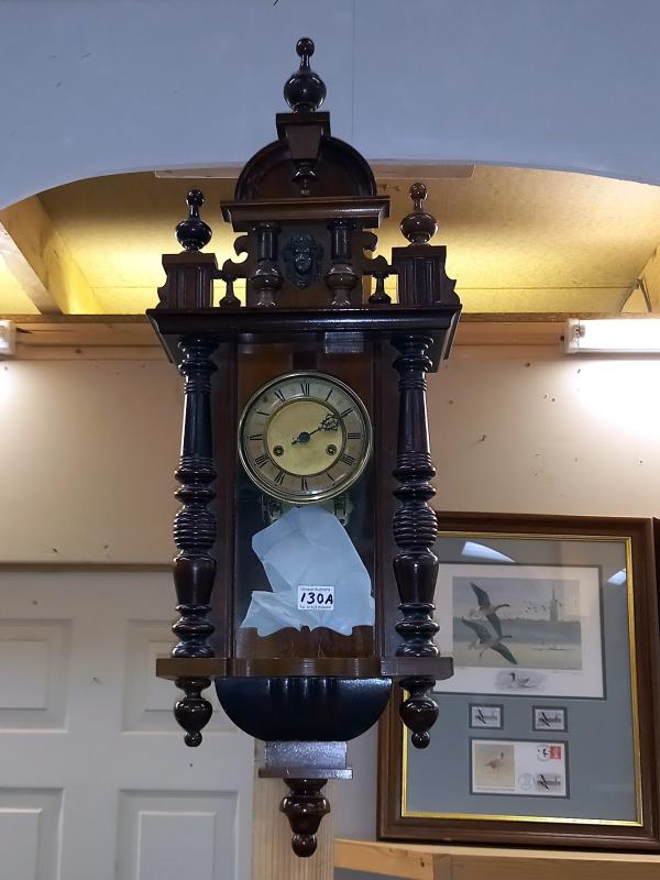 A wall clock with pendulum