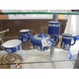 A Wedgwood Blue Jasper three piece tea set and two jugs.