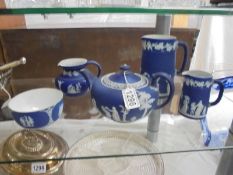 A Wedgwood Blue Jasper three piece tea set and two jugs.