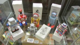 Five boxed collectable tin plate clockwork robots and a drumming soldier.