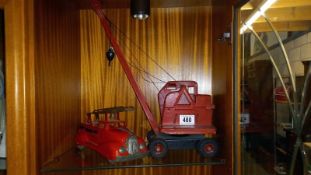 A pressed steel Tri-ang crane and an early fire engine