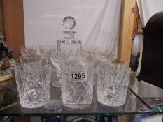 A cut glass decanter and two sets of six glasses.