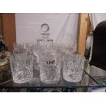 A cut glass decanter and two sets of six glasses.