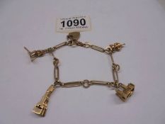 A 9ct gold bracelet with four charms, 18.5 grams.