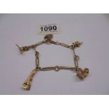 A 9ct gold bracelet with four charms, 18.5 grams.