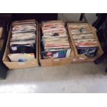 Three boxes of 45 rpm records.