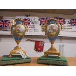 A pair of continental porcelain a gilt urns.