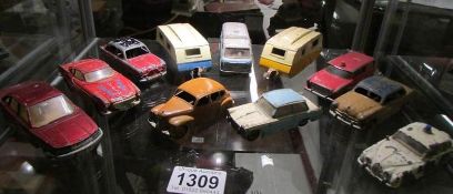 A quantity of play worn 1950/60's die cast Dinky toys including Ford, Triumph, Jaguar etc.,