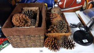 A quantity of large pine cones and 3 wicker baskets