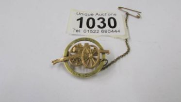 A WW1 brooch featuring a cannon marked Amiens 1914-15-16.