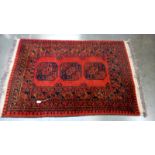 A red & black Middle eastern geometric patterned rug - 165cm x 102cm. COLLECT ONLY