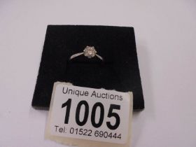 A white gold floral diamond ring, size N half, 1.85 grams.