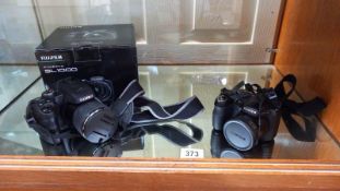 A Fuji film Finepix SL1000 boxed camera and a Fuji film Finepix S1800 camera