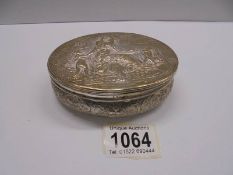 An oval embossed silver box featuring a Grecian scene, 199 grams.