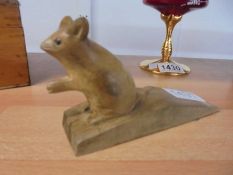 A wooden doorstop with a carved mouse (not Mouseman).