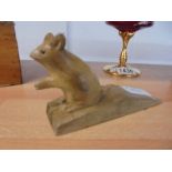 A wooden doorstop with a carved mouse (not Mouseman).