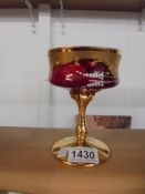 A gilded hand decorated goblet.