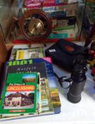 A pair of Halina 16 x 50 binoculars, a ships wheel clock and a quantity of books on walks in Britain