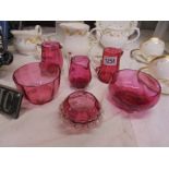 Three cranberry glass jugs and three cranberry glass bowls.