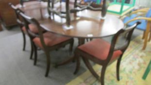 An oval double pedestal extending dining table and six chairs, COLLECT ONLY.