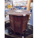 An Asian carved wood occasional table with centre inlay (slight damage to inlay) COLLECT ONLY.