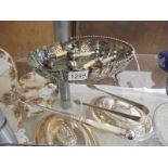 A silver plate basket, toasting fork, sugar tongs and two pairs of knife rests.