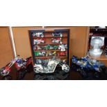 A collection of plastic motorbike models including a display case