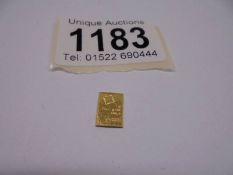 A 1 gram fine gold bar.